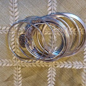 Lot of 16 silver tone stacking bangles, inc. Alex & Ani